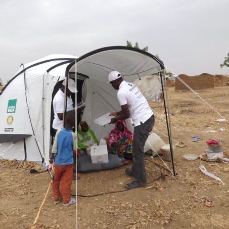 People outside a tent in Cameroon