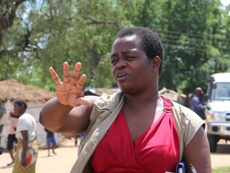 Three people talking in Malawi