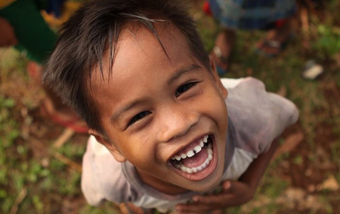 Little boy smiling up at camera